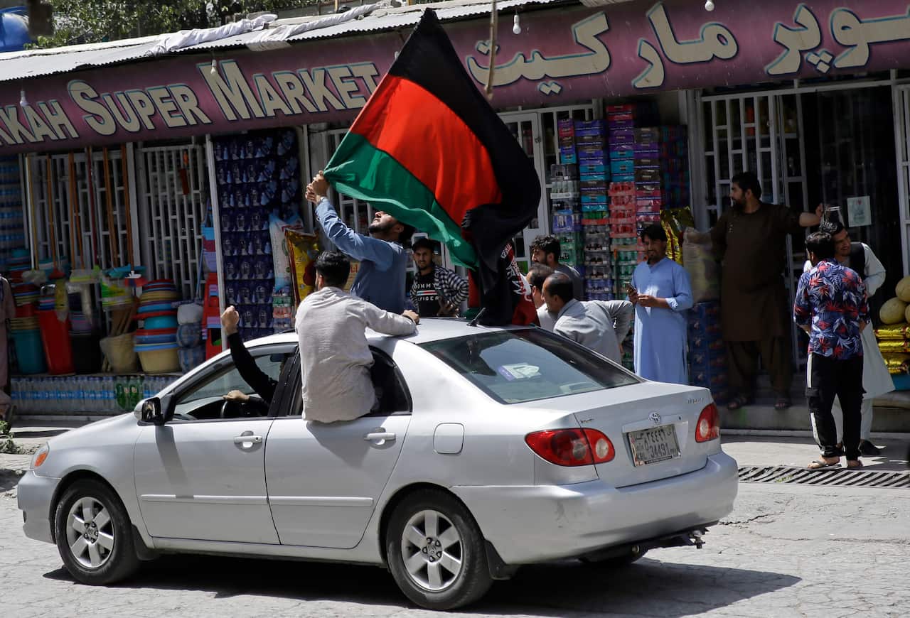 Afghans hold National flag during the Independence Day in Kabul, Afghanistan, Thursday, Aug. 19, 2020. (AP Photo/Rahmat Gul)