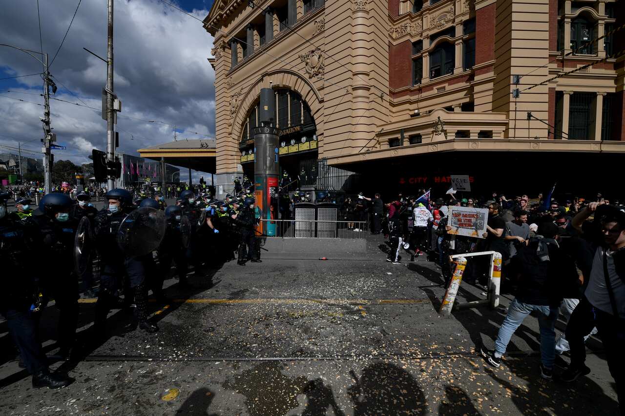 Protesters are pepper sprayed by police during an anti-lockdown protest in the central business district of Melbourne.