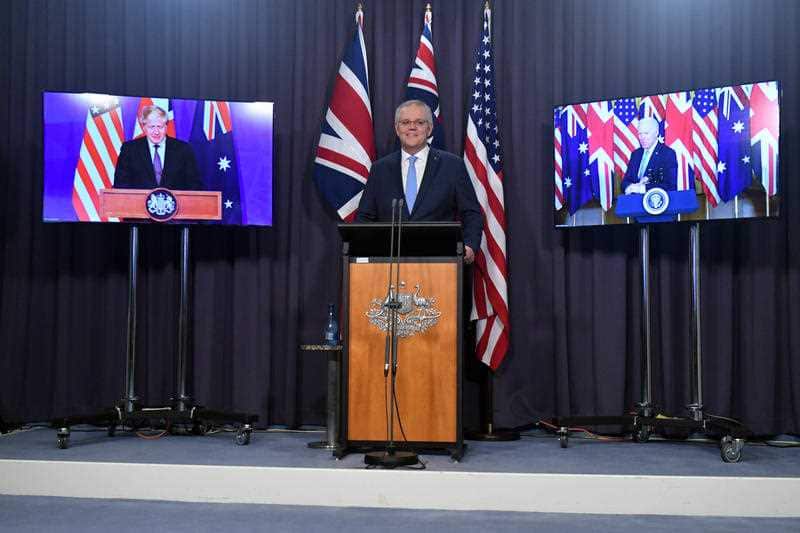 Britain’s Prime Minister Boris Johnson, Australia’s Prime Minister Scott Morrison and US President Joe Biden at a joint press conference via AVL from The Blue Room at Parliament House in Canberra, Thursday, September 16, 2021. 