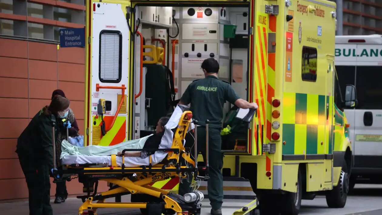 Paramedics unload a patient from an ambulance parked outside the emergency department at The Royal London Hospital in Whitechapel in London, England.