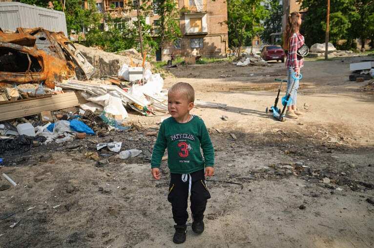 A boy walks through the wreckage of a destroyed building. As the city of Kiev tries to return to normality, the streets are a reminder that the war is still raging.