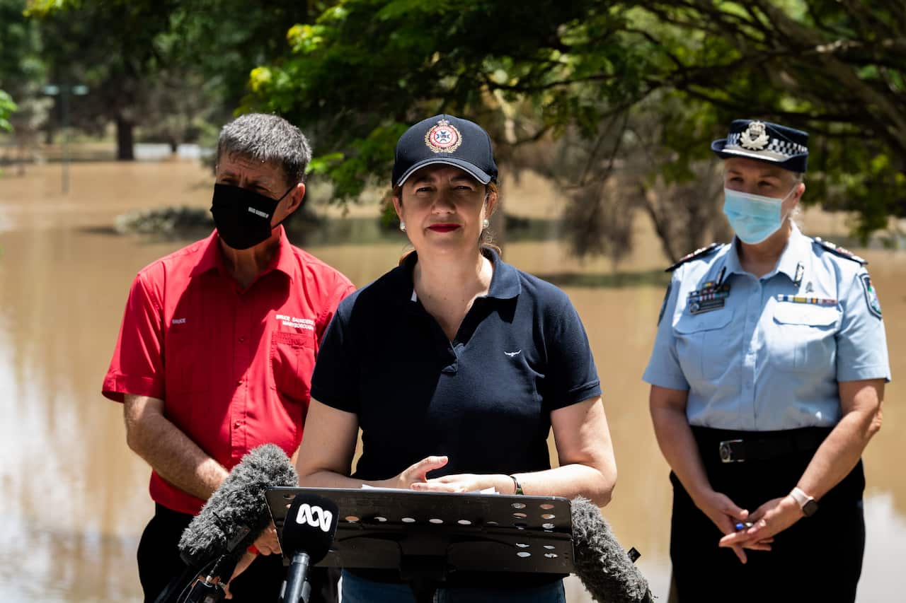 QueenslandPremier Annastacia Palaszczuk (centre) speaks to the media during a press conference in Maryborough, Tuesday, January 11, 2022. The regional city of Maryborough is mopping up after an underground stormwater mechanism failed, allowing floodwater