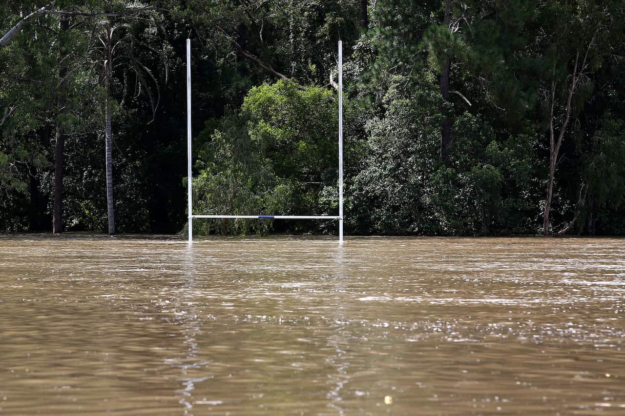 Local flooding in Cooran on the Sunshine Coast, Queensland, Wednesday, February 23, 2022. The body of a 60-year-old has been found in a submerged car in a creek on Queensland's Sunshine Coast after severe rainfall triggered flash floods. (AAP Image/Jono S