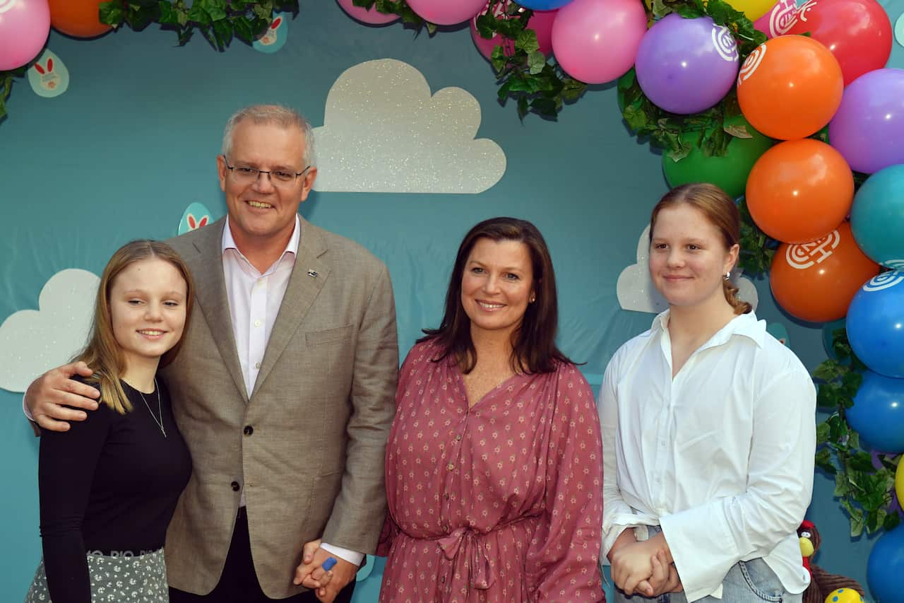 Prime Minister Scott Morrison, wife Jenny and daughters Abbey and Lily pose for a photograph after arriving for an Easter service at the Horizon Church in Sutherland on Day 7 of the 2022 federal election campaign, in Sydney, in the Division of Cook. Sunda