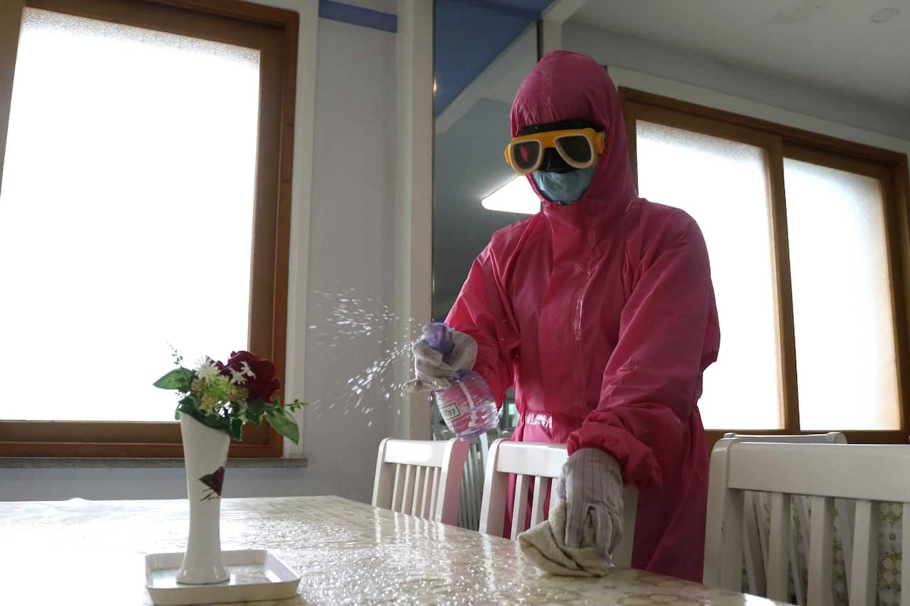 FILE - An employee of Pyongyang Dental Hygiene Products Factory disinfects the floor of a dinning room as the state increased measures to stop the spread of illness in Pyongyang, North Korea, May 16, 2022. A top official at the World Health Organization s