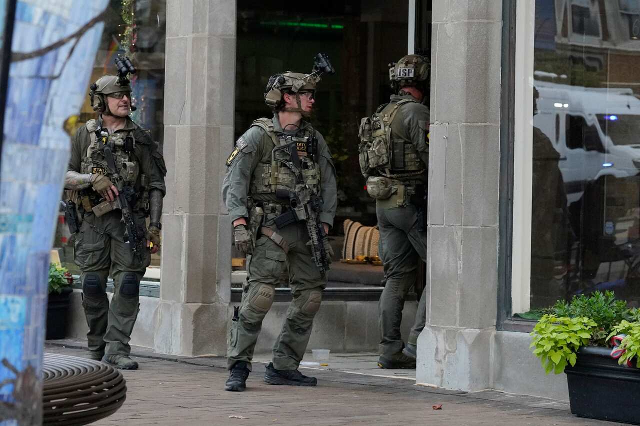 Law enforcement conduct a search after a mass shooting at the Highland Park Fourth of July parade in downtown Highland Park, Ill., a Chicago suburb.