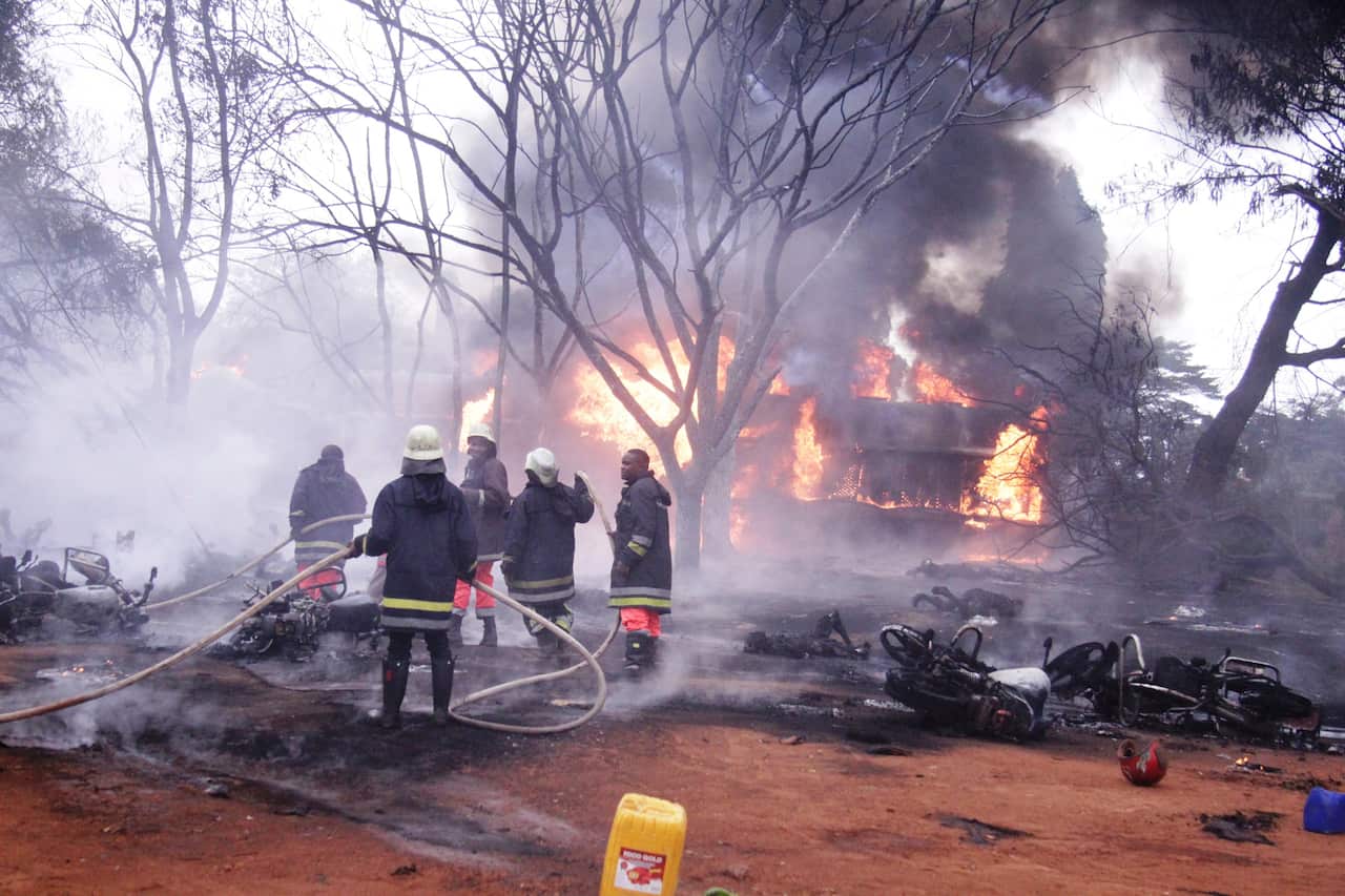 Fire fighters try to put off fire of the patrol tanker, in Tanzania