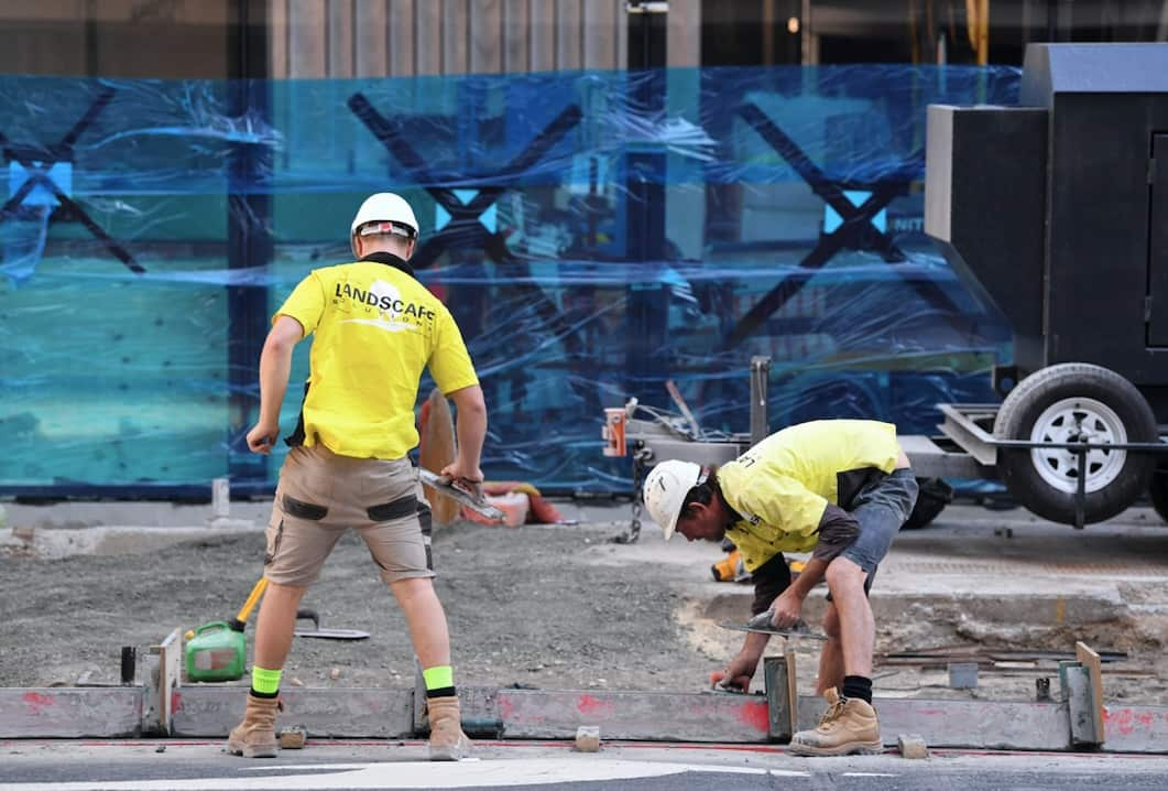 Workers are seen at a construction site in Brisbane.