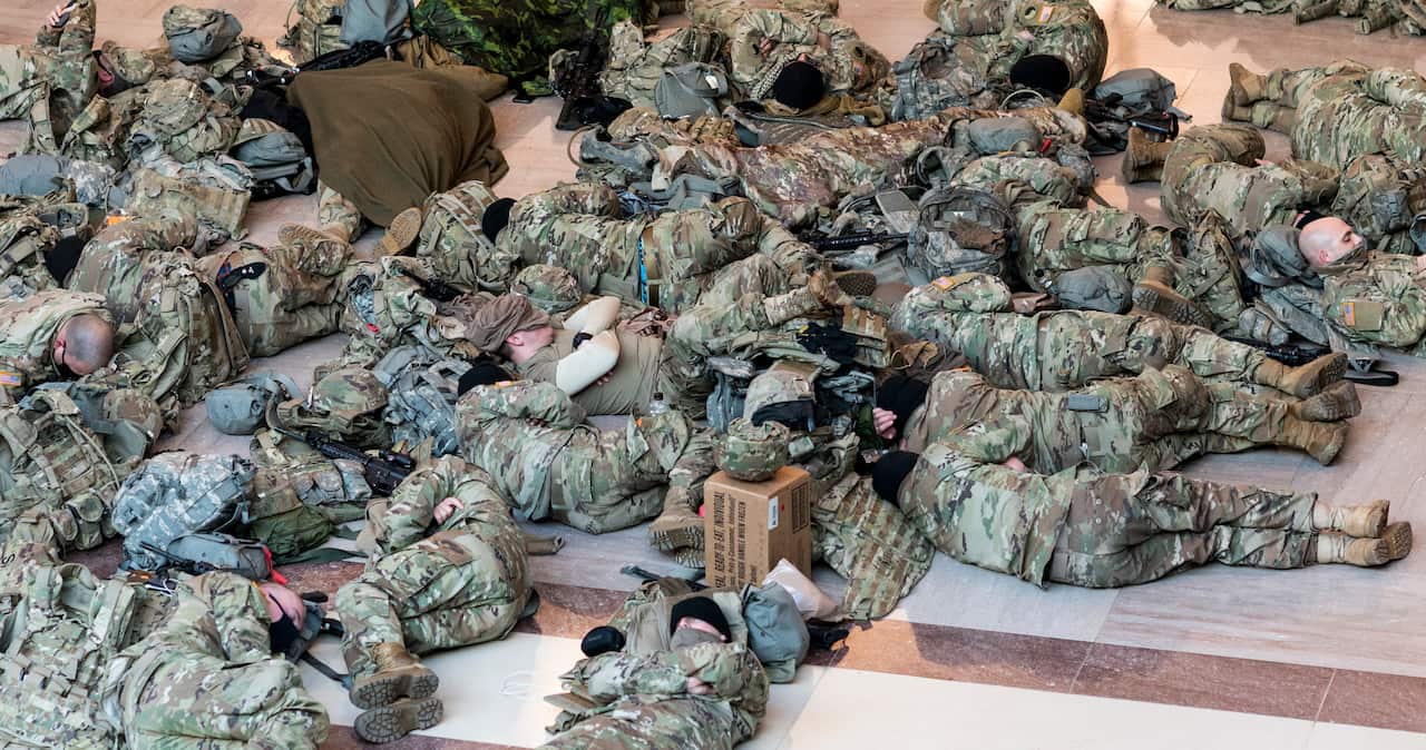 National Guard soldiers have been photographed sleeping in the Capitol building ahead of a House vote to impeach Donald Trump.