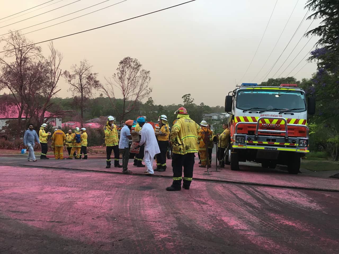 Members of the local Sikh community hand out home-cooked food to Hornsby's firefighters.
