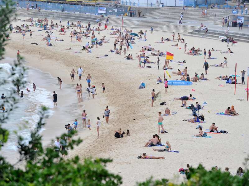 People enjoy the sand at Coogee Beach