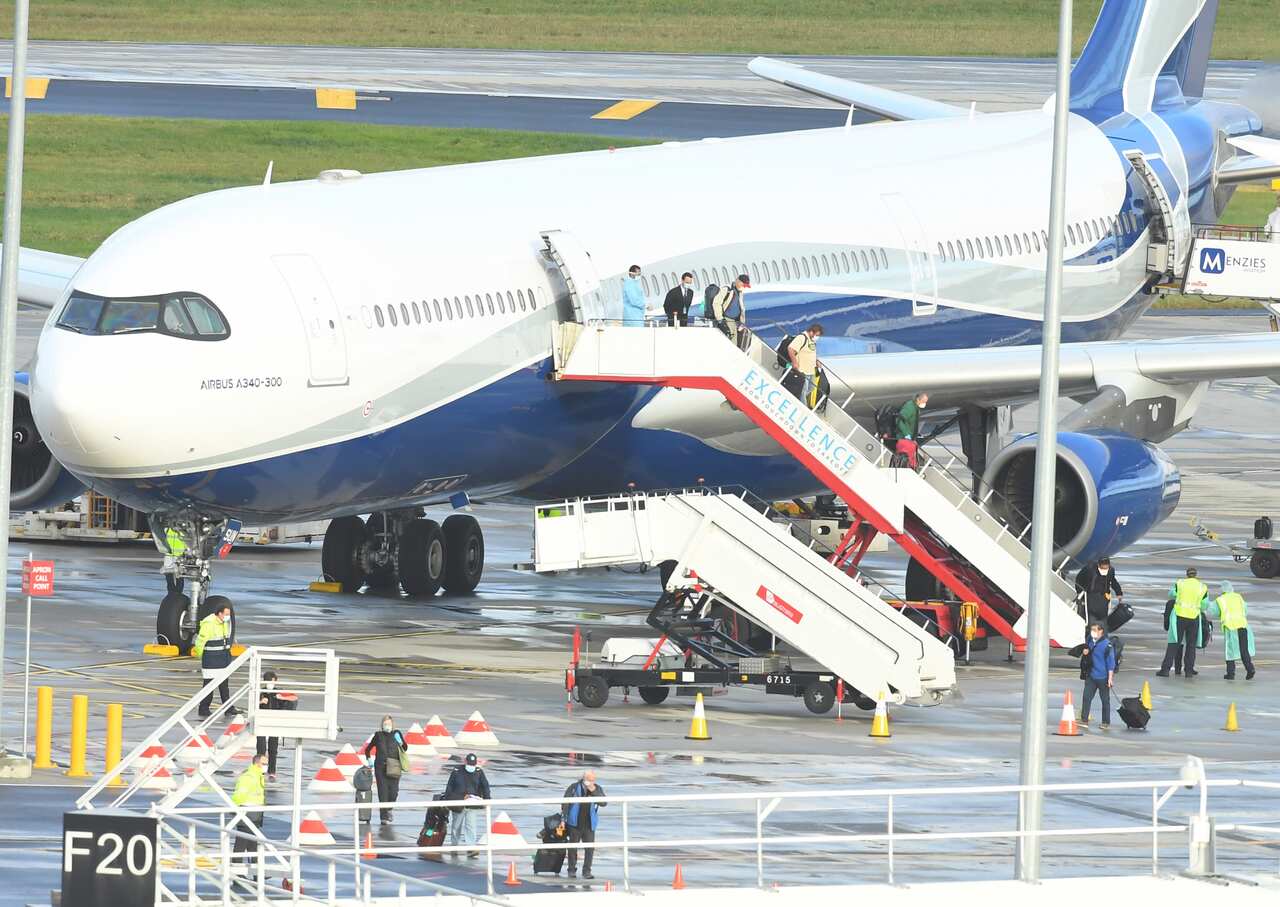 Passengers from aboard the Antarctica Cruise ship The Greg Mortimer arrive at Melbourne Airport from Uruguay, Sunday, April 12, 2020.