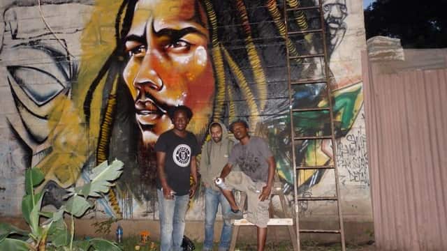Kenyan artists in front of one of their creations 