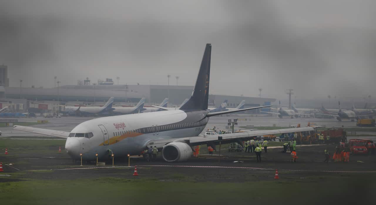A domestic flight that skidded off the main runway late Monday night during heavy monsoon rains is see at the Mumbai airport in Mumbai,India, Tuesday, July 2, 2019. (AP Photo/Rafiq Maqbool)
