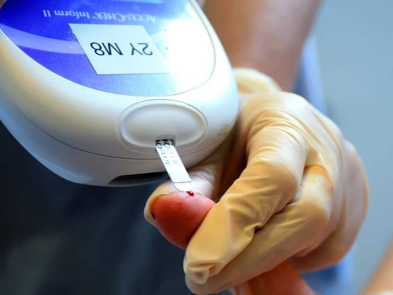 A file image of a nurse giving a patient a diabetes test