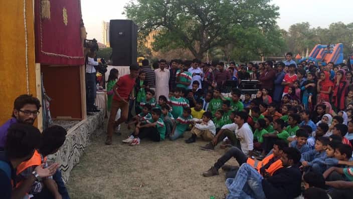 Children watching the puppet show in Karachi.
