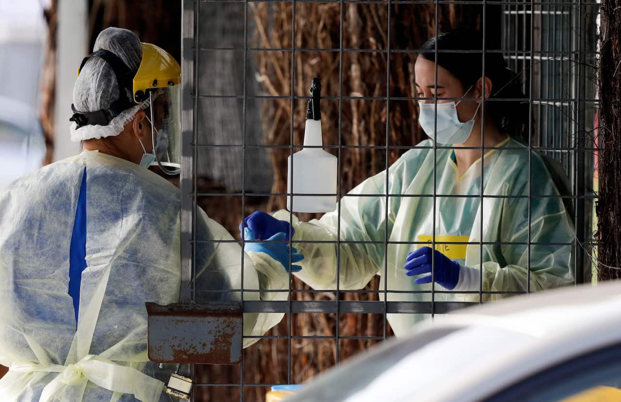 Medical staff prepare to take COVID-19 tests at a drive-through assessment centre in Christchurch, New Zealand.