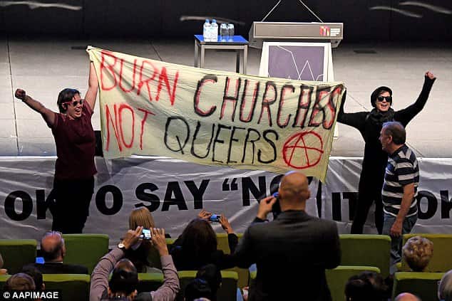 The sultry kiss wasn't the only disruption that night though with protesters storming the hall with a sign that said 'burn churches not queers'