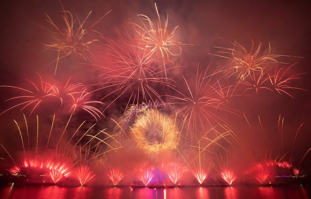 Fireworks explode over the London Eye Ferris wheel by the River Thames in London, to mark the start of the new year, Wednesday, Jan. 1, 2020. (AP Photo/Matt Dunham)