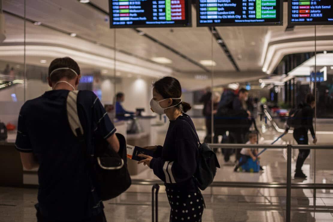 People wearing protective surgical masks at Changi Airport in Singapore.