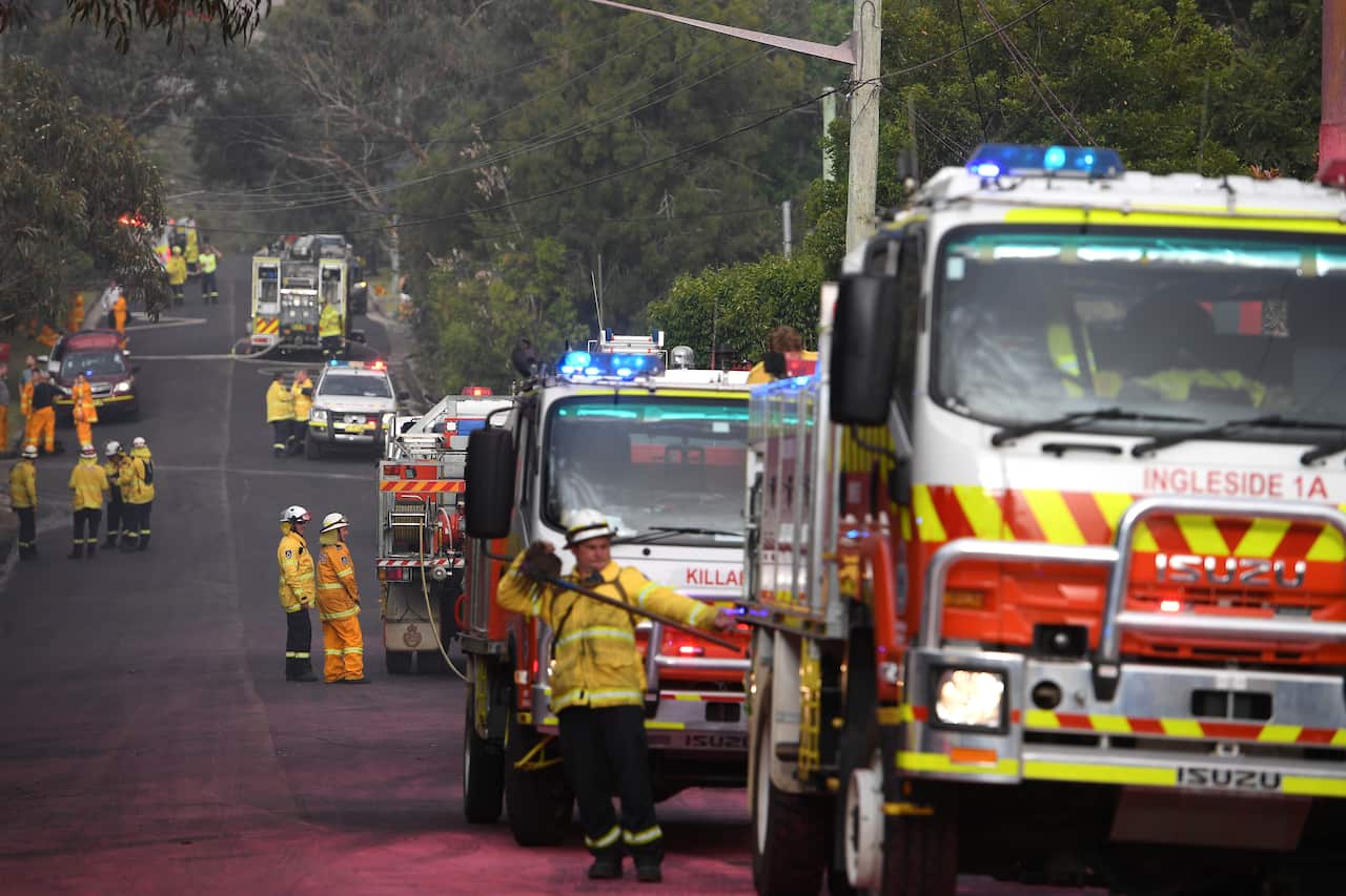 Crews rushed to protect properties on Canoon Rd, South Turramurra on Tuesday afternoon.