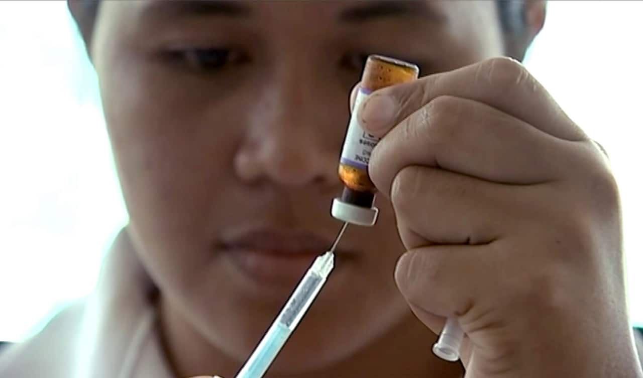 A New Zealand health official prepares a measles vaccination at a clinic in Apia, Samoa