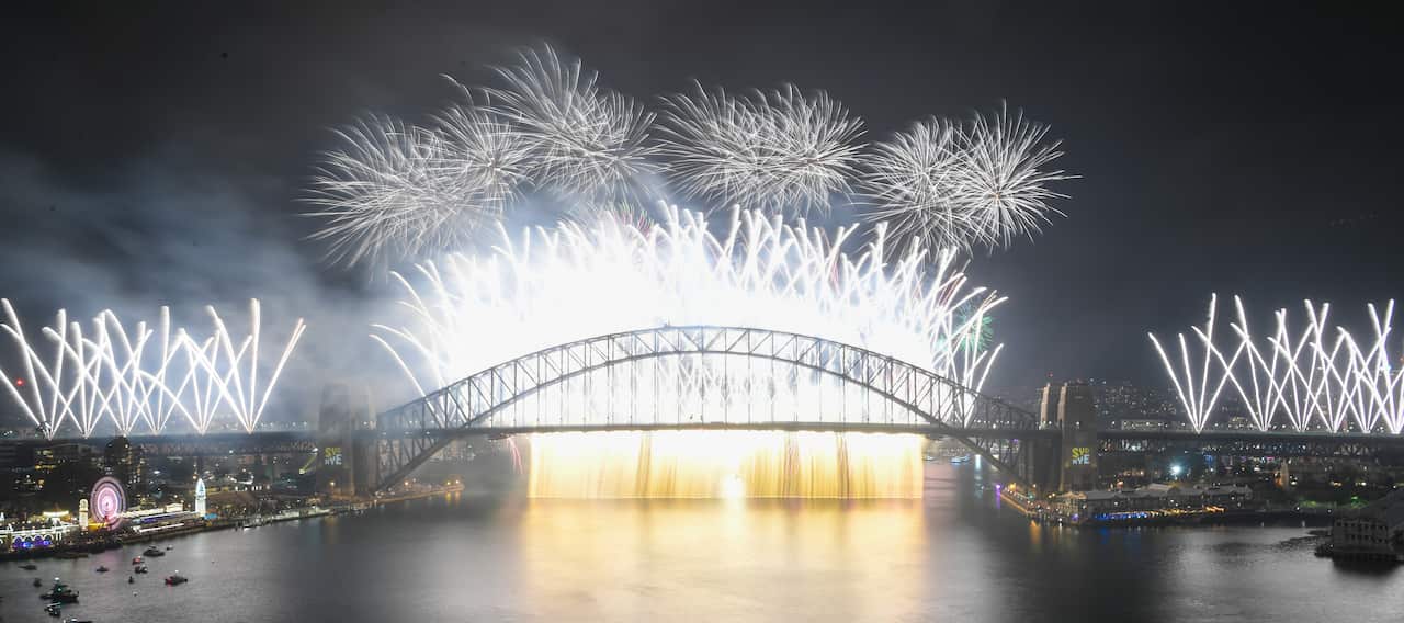 The Midnight fireworks explode over the Sydney Harbour Bridge on Sydney Harbour during the Year's Eve celebrations in Sydney, Tuesday, December 31, 2019. (AAP Image for City of Sydney/Lukas Coch) NO ARCHIVING, EDITORIAL USE ONLY