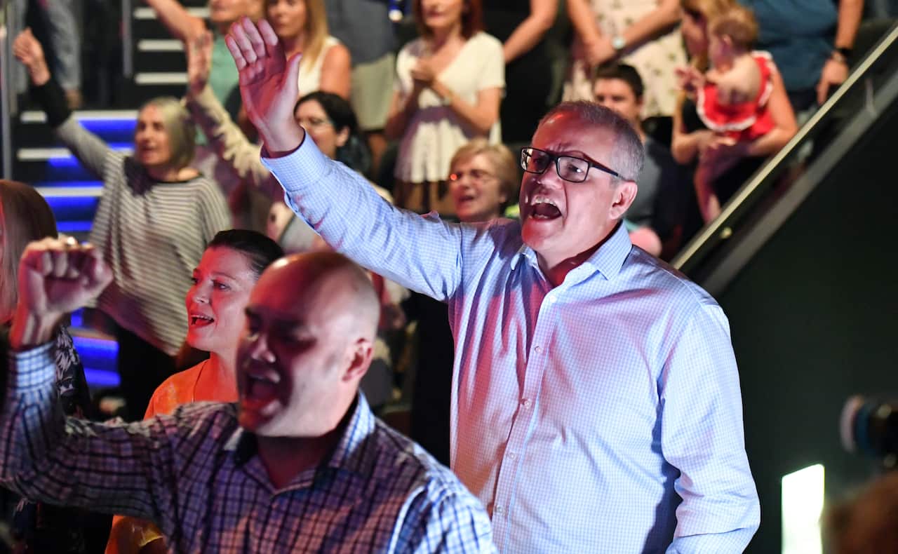 Prime Minister Scott Morrison and wife Jenny sing during an Easter Sunday service at his Horizon Church at Sutherland in Sydney, Sunday, April 21, 2019.