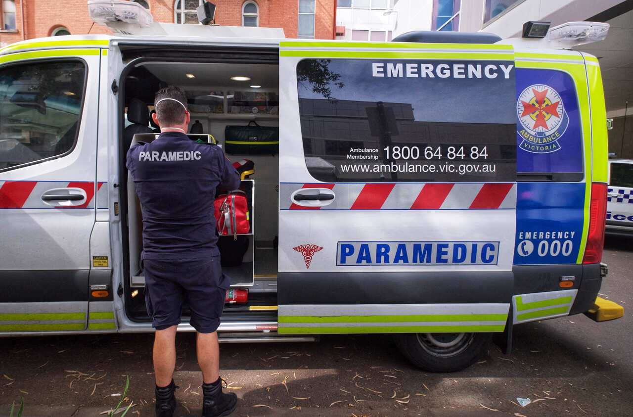 A file image shows paramedics by an ambulance outside St. Vincent hospital in Melbourne, Tuesday, 11 January, 2022. 