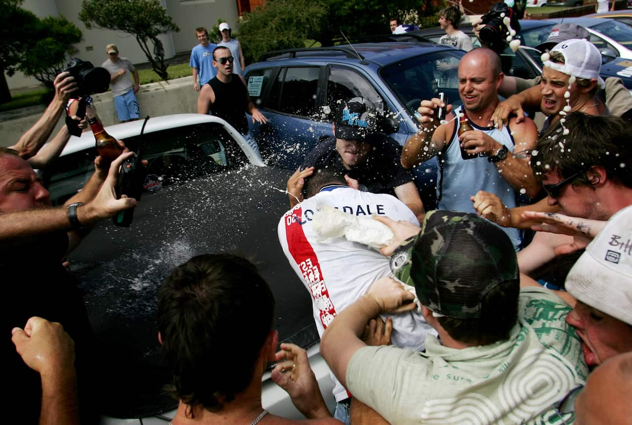 A man is attacked by a crowd at Cronulla Beach during the riots.