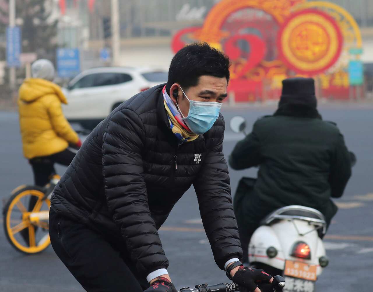 A man wears a mask in Beijing. The virus has spilled over China’s borders and spread to at least 25 countries worldwide.