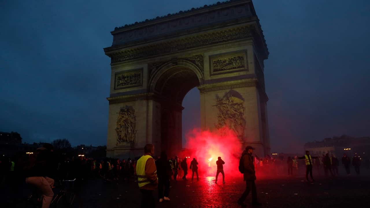 Protesters wave flares.