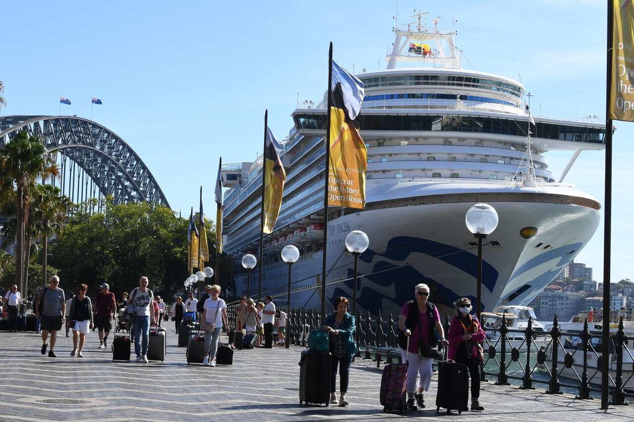 Cruise ship passengers disembark from the Ruby Princess at Circular Quay in Sydney, Thursday, 19 March, 2020.