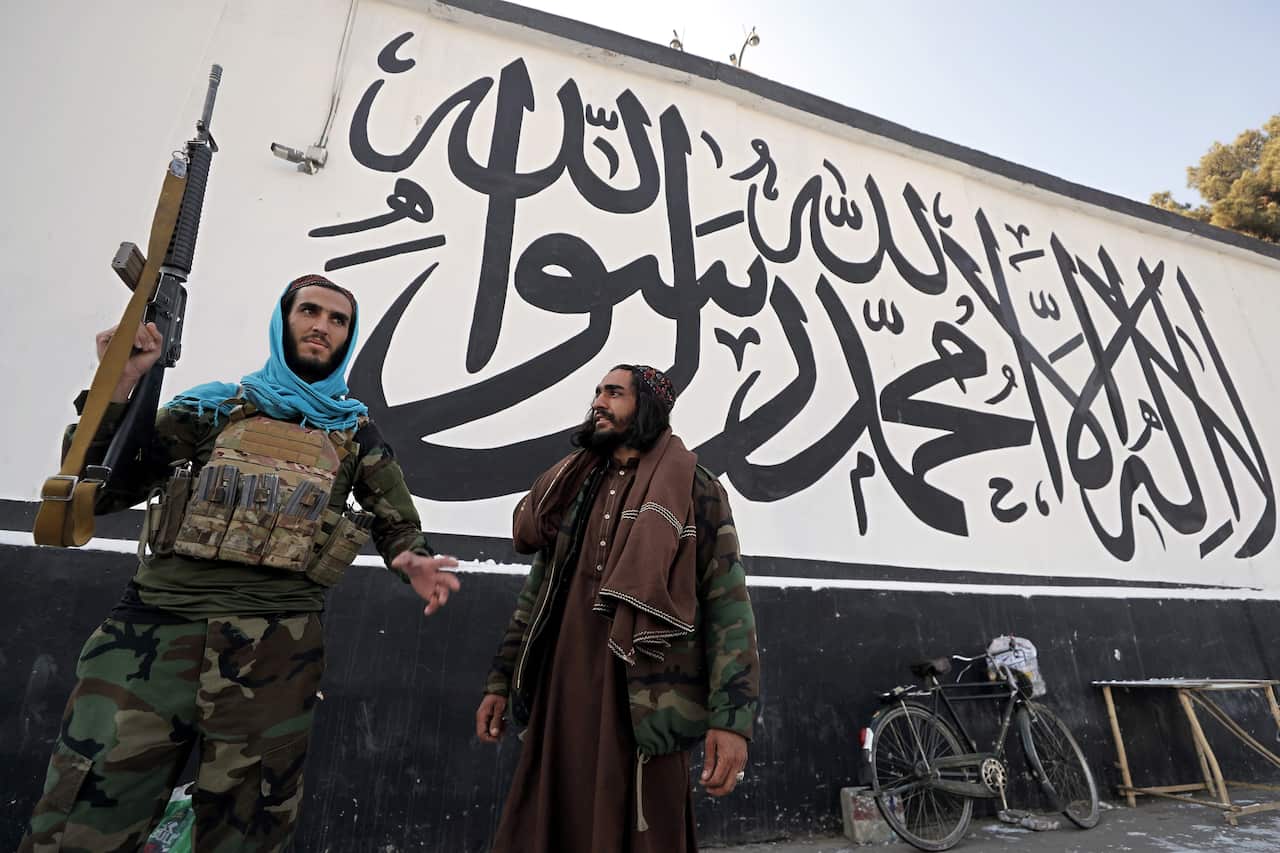 Taliban stand guard outside the building of former US embassy