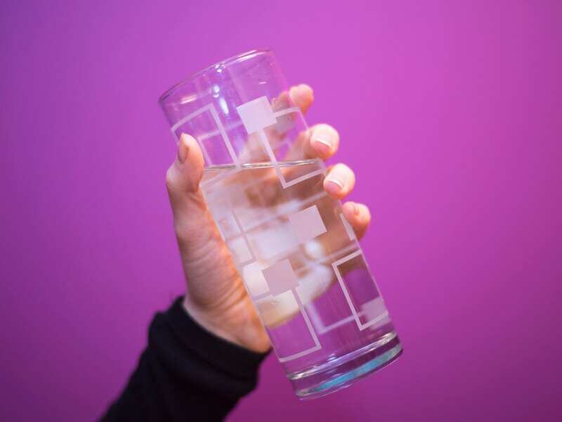 Someone holding a glass of water