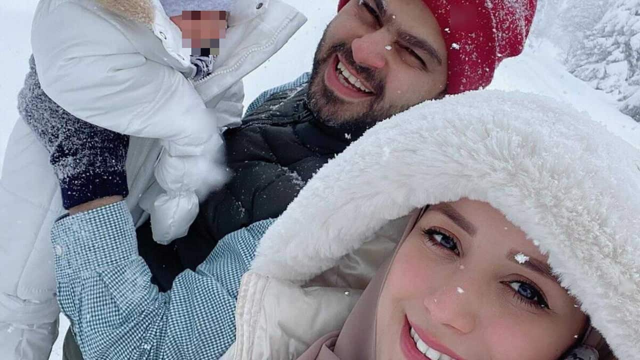 Dr Al-Hasani with his wife, Hana, and young child. 