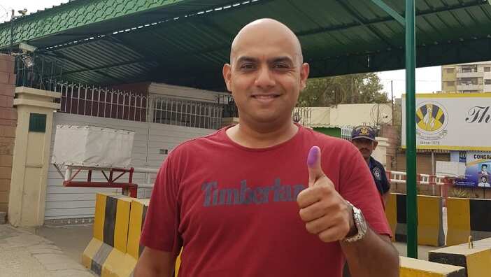 Voter showing thumb with ink