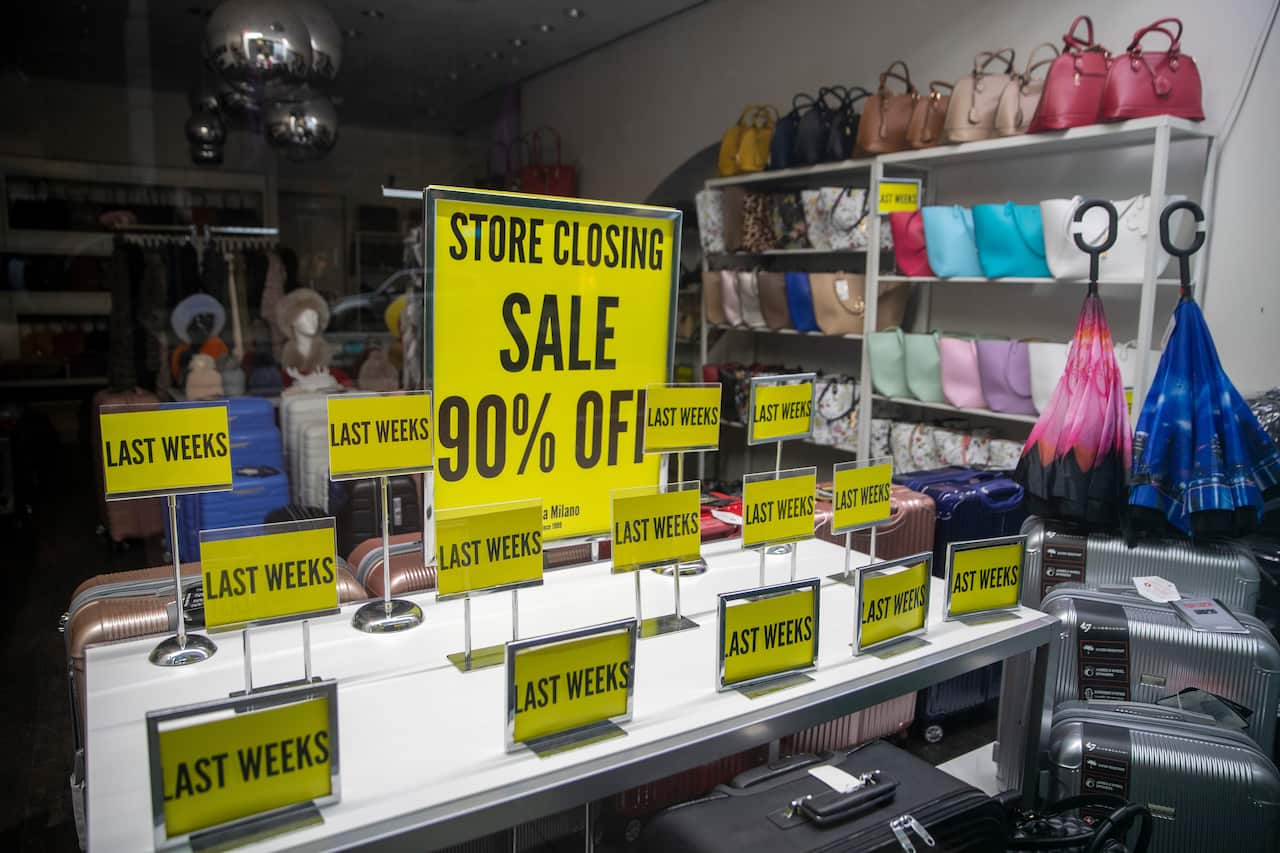 "Store Closing" sale signs are on display at a shop on Madison Avenue in New York.