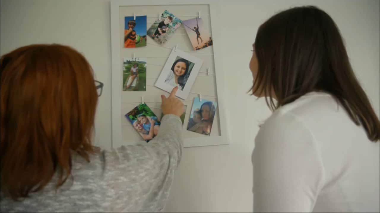 Taryn shows SBS News photos of her children.