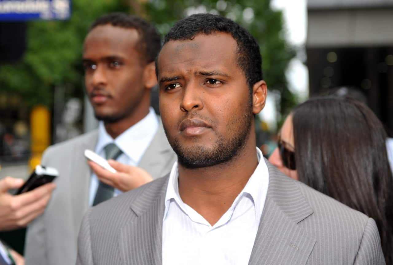 File image of Yacqub Khayre (centre) leaving court in Melbourne, Thursday, Dec. 23, 2010.