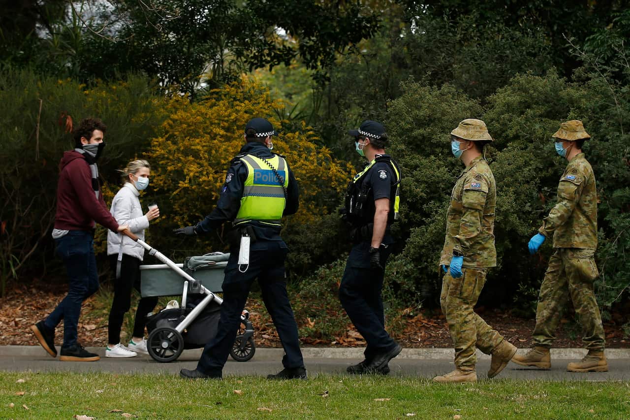 ADF personnel and Victorian police officers are seen patrolling the Botanic Gardens in Melbourne.