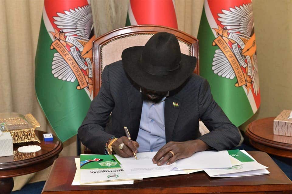 President Salva Kiir signing documents 
