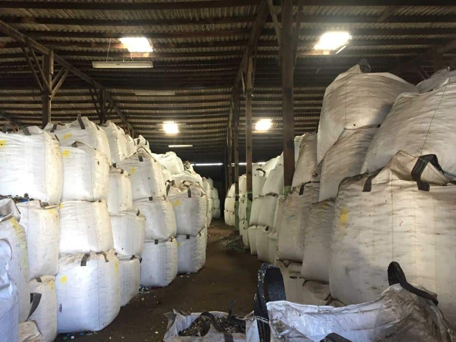 Inside Polytrade's warehouses, there are rows upon rows of giant bags storing unused glass.