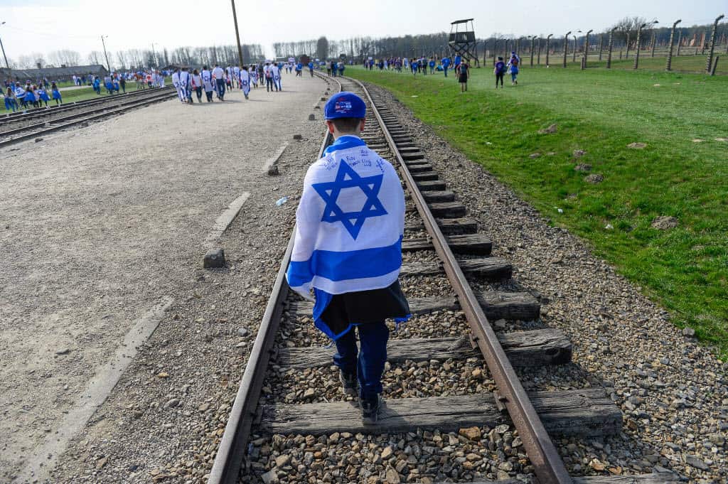 A man carries a Israeli flag at the former Nazi German Auschwitz-Birkenau death camp during the 'March of the Living' at Oswiecim.