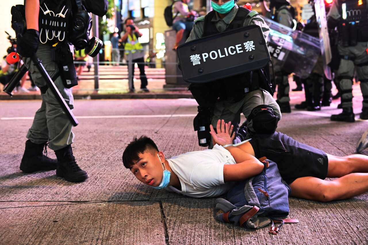 Police officers detain a protester during a rally against a new national security law on July 1 in Hong Kong.