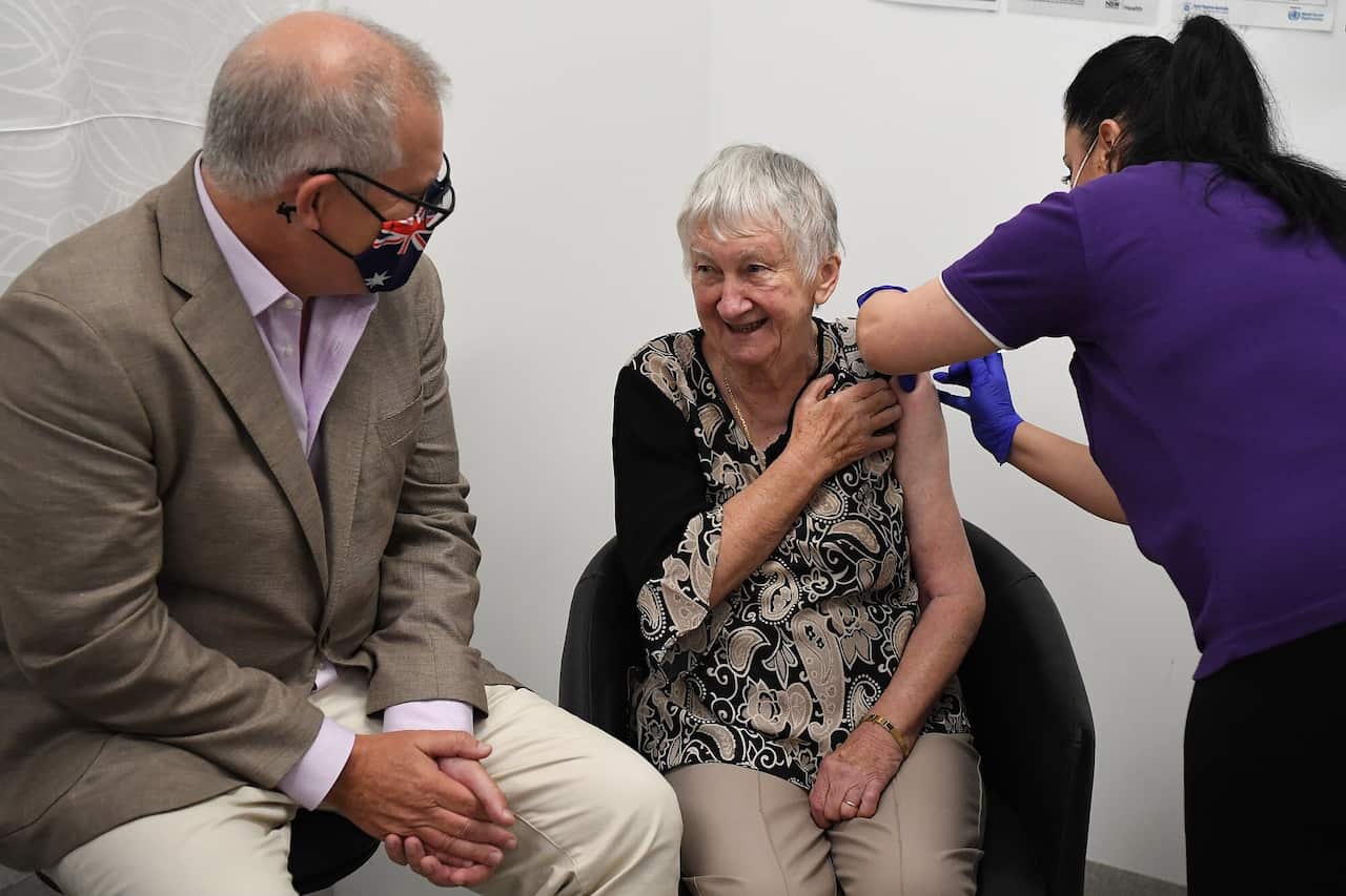 Australian Prime Minister Scott Morrison joins aged care resident Jane Malysiak (left) as she receives the first COVID-19 vaccine in Australia