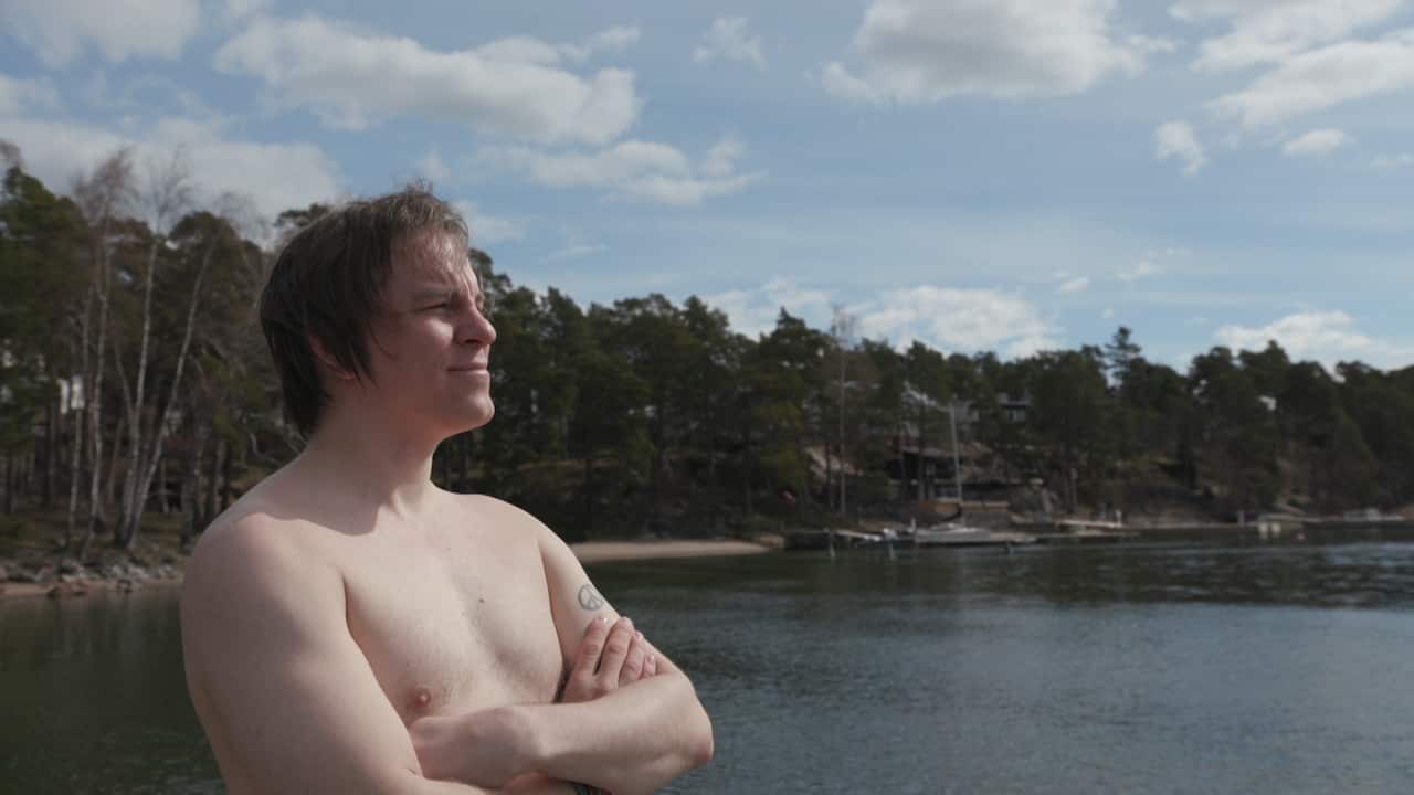 Frank Martela happiness expert enjoying an icy dip in the sea.