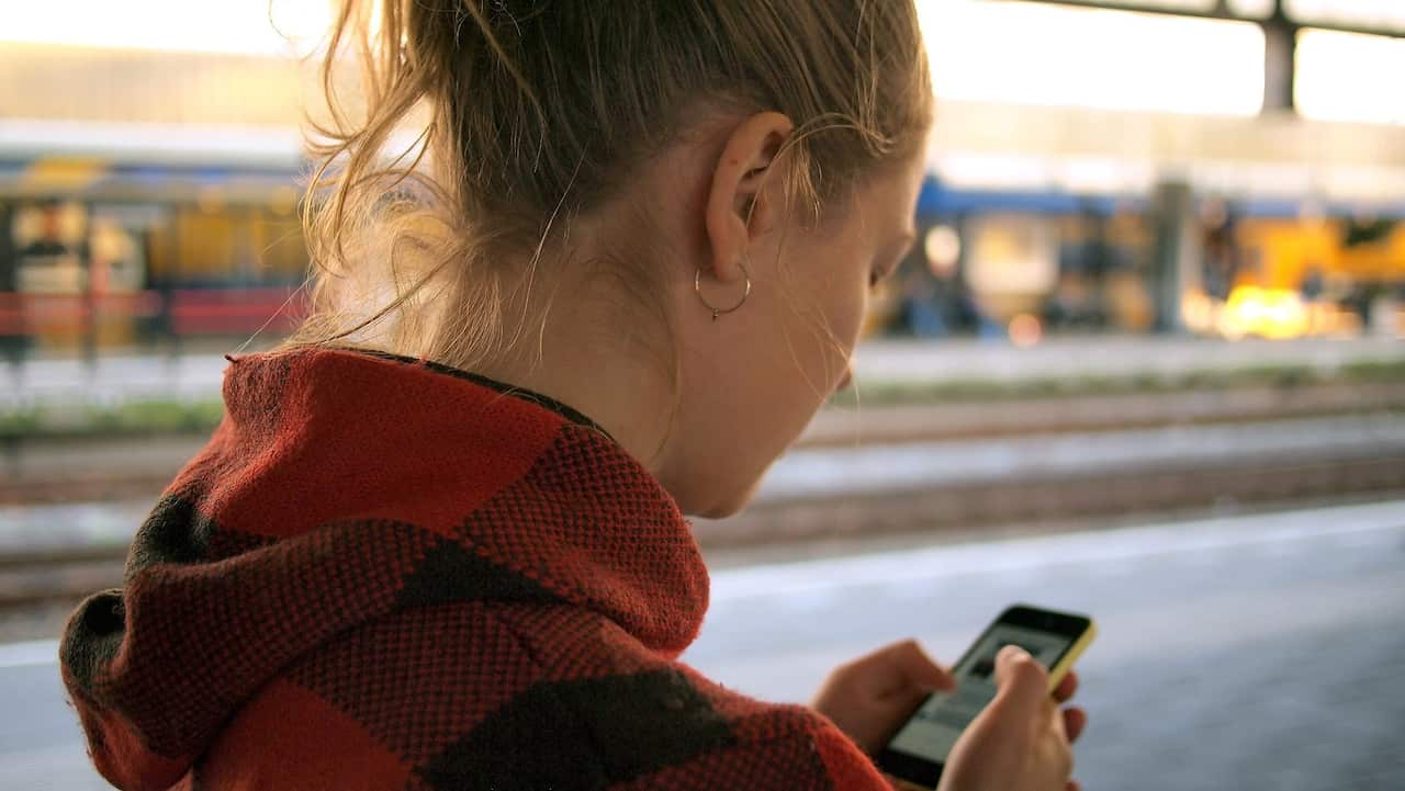 Young woman looks at phone