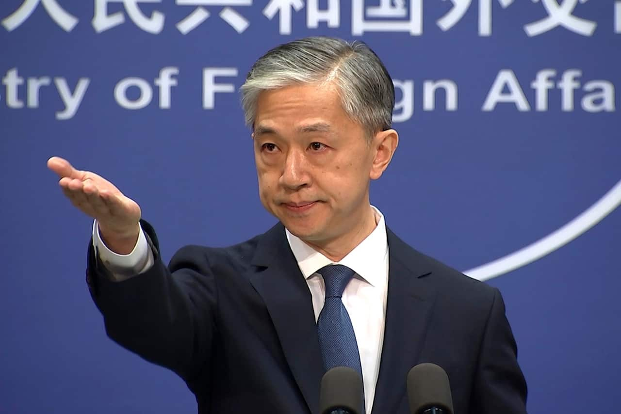 Foreign ministry spokesperson Wang Wenbin gestures during the daily briefing held at the Foreign Ministry in Beijing.