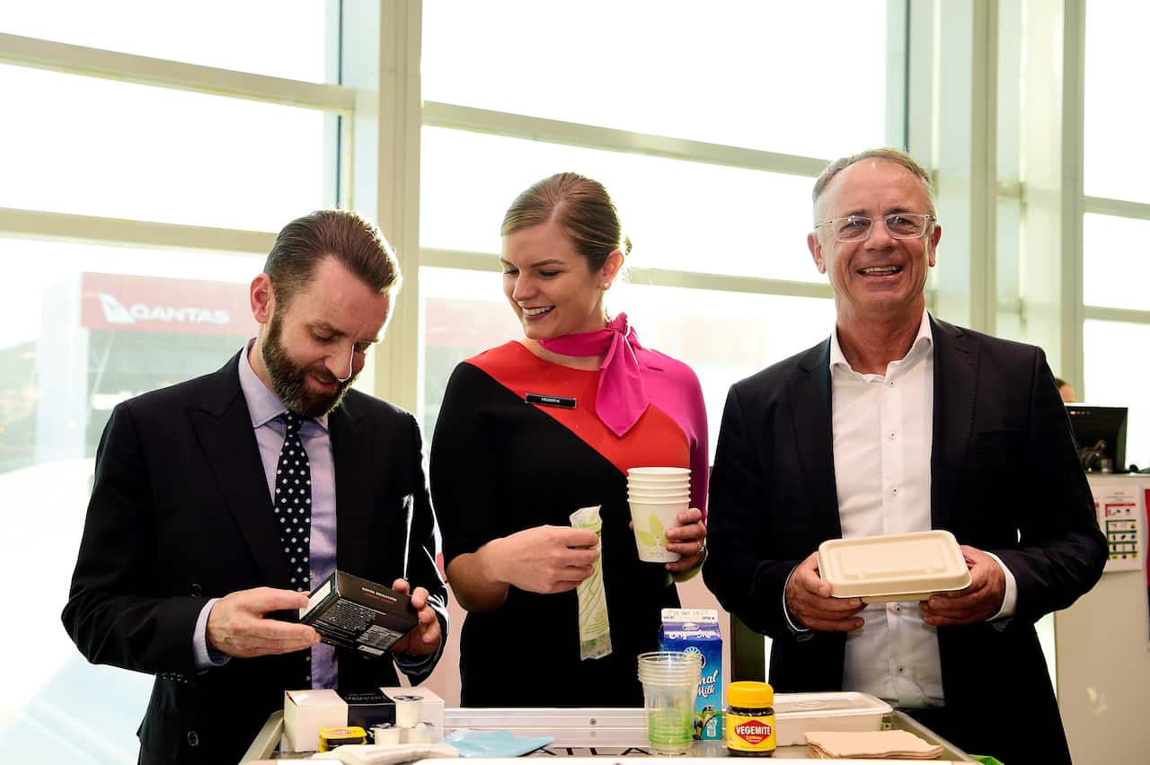 Qantas group executive for sustainability Andrew Parker, left, Qantas flight attendant Madeline Rowcliff and Qantas Domestic CEO Andrew David.